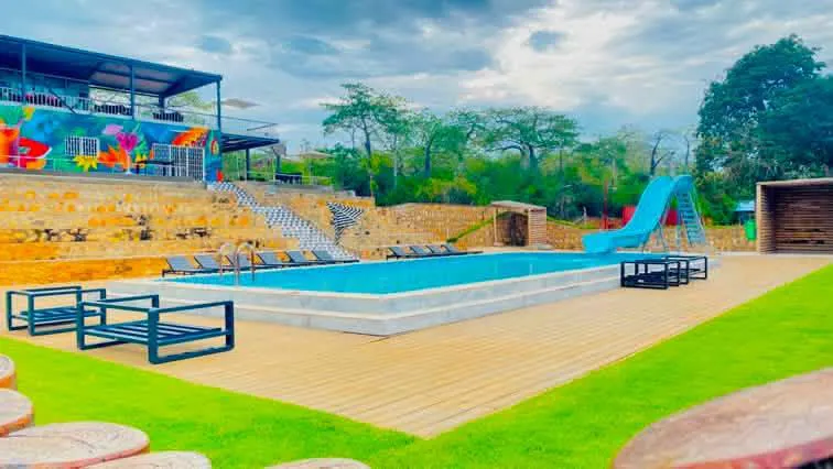 Second swimming pool with water slide and sun deck